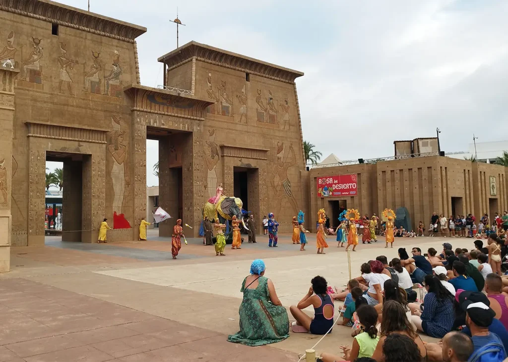 Performers in colourful costumes during the 'Los Sueños de Egipto' show, in front of the monumental gateway to the Egypt area at Terra Mítica.