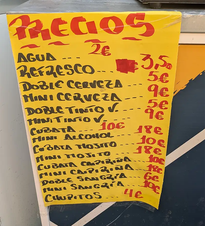 Cartel con los precios de bebidas en una caseta de las fiestas de Madrid, agua, refrescos, cerveza y cócteles.