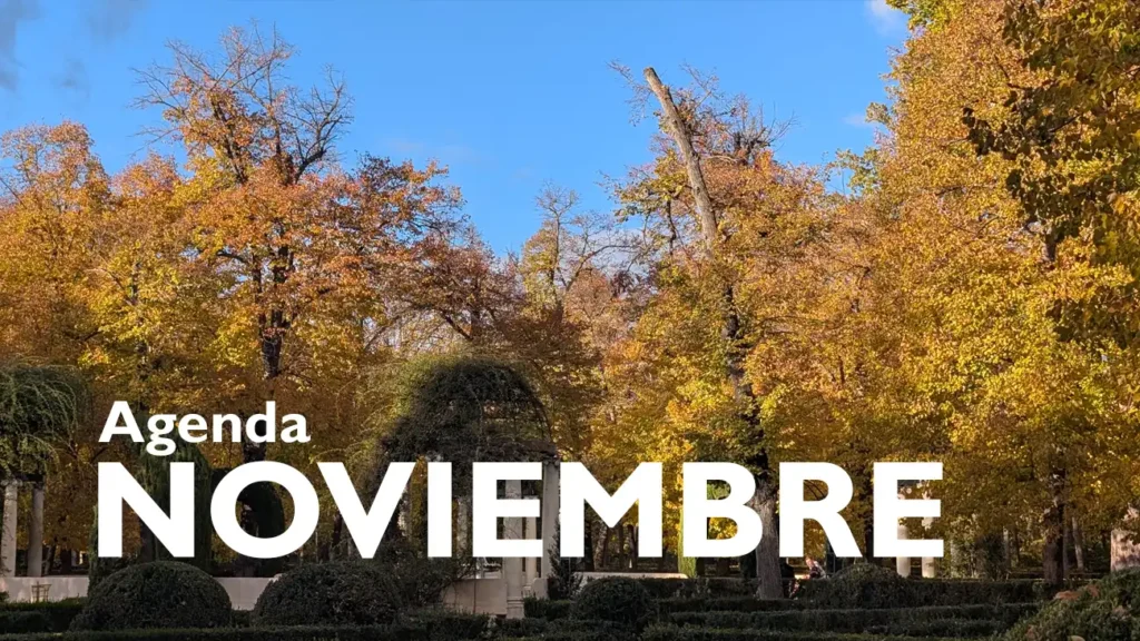 Parque durante o outono com árvores em tons de amarelo e laranja, sob o texto "Agenda noviembre" em branco.